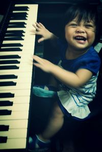 Close-up of smiling boy playing at home