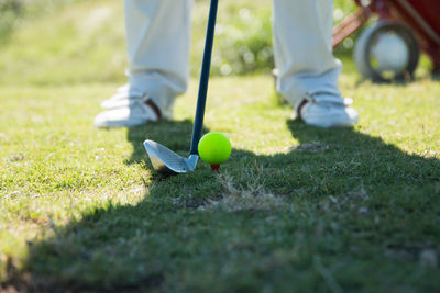 Low section of man playing golf