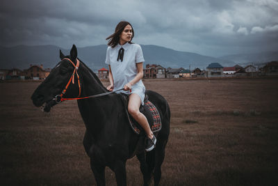 Woman on horse in field