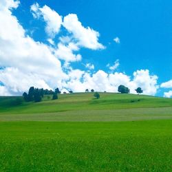 Scenic view of field against cloudy sky