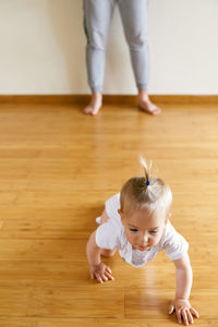 High angle view of cute baby crawling on floor