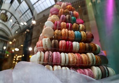 Stack of multi colored macaroons for sale on table