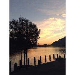 Scenic view of lake against sky at sunset