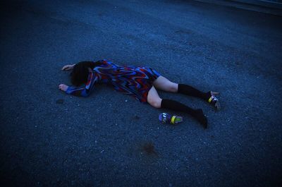 High angle view of man lying down on floor