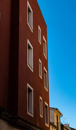 Low angle view of building against clear blue sky