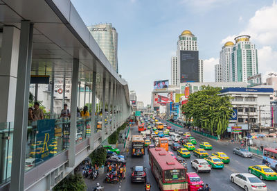 Panoramic view of city street and buildings against sky