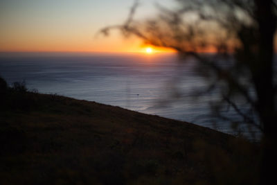 Close-up of sea against sky during sunset