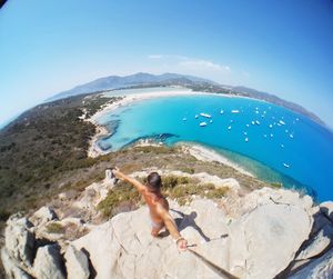 Man swimming in sea against clear blue sky