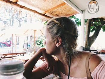Portrait of woman looking through window