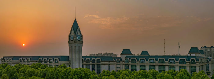 Buildings against sky during sunset