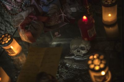 Lit candle in dark room