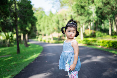 Cute girl standing on road