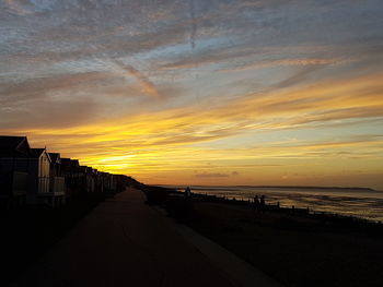 Scenic view of beach against sky during sunset