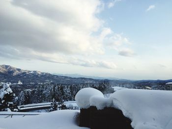 Snow covered landscape against sky