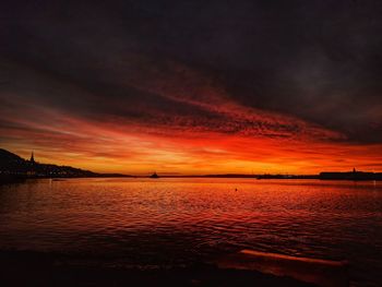 Scenic view of dramatic sky over sea during sunset