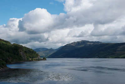 Scenic view of sea and mountains against sky