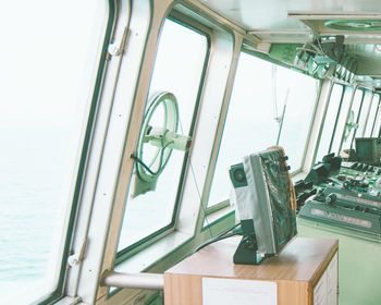 Low angle view of electric lamp on table by window