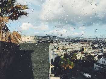 Close-up of wet glass window in rainy season