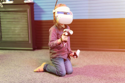 Portrait of boy playing with toy at home