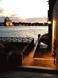 Pier in sea at sunset