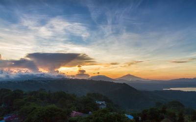 Scenic view of mountains against orange sky