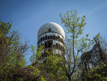 Low angle view of teufelsberg tower against clear blue sky, berlin