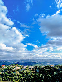 High angle view of buildings against blue sky