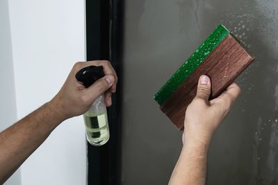 Close-up of man holding hand at home