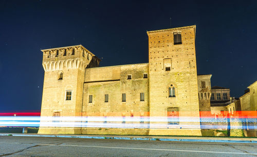 Low angle view of building against clear sky at night