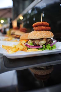 Close-up of burger and french fries in plate on table