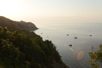 Scenic view of mountain and sea against sky