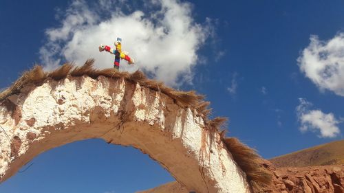 Low angle view of rock formation against sky