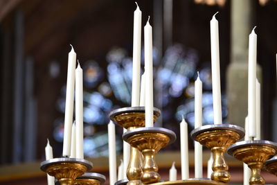 Low angle view of candles on holder at church