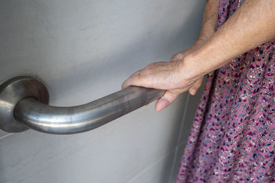 Asian senior woman patient use toilet bathroom handle security in nursing hospital