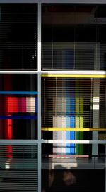 Full frame shot of glass window with multi colored building