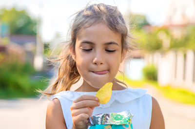 Cute girl eating potato chip