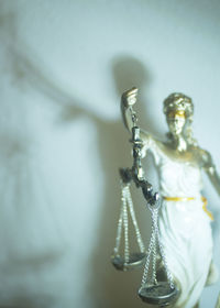 Close-up of lady justice against wall