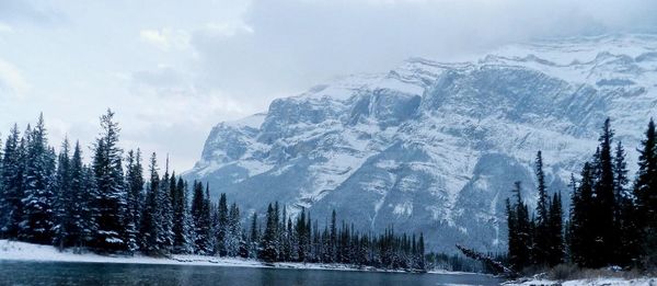 Scenic view of snowcapped mountain against cloudy sky