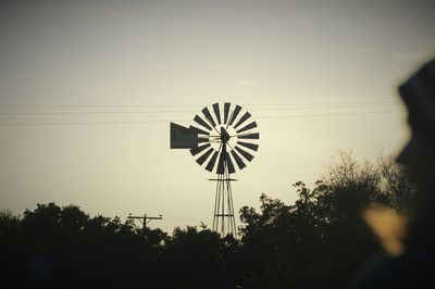 Low angle view of windmill against sky