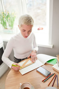 Woman working on table at home