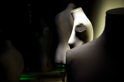 Close-up of mannequin in black background