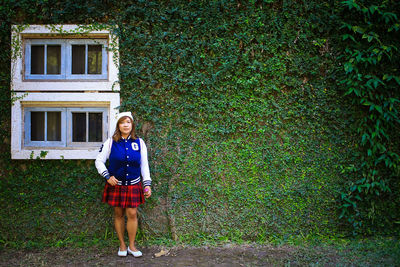 Full length of young woman standing on field