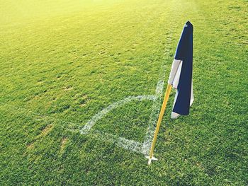 White blue flag in corner of football playground, lazy wind blowing