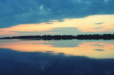 Scenic view of calm lake at sunset