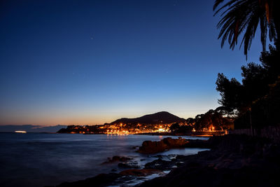 Scenic view of sea against clear sky at night