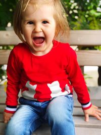 Portrait of cute girl sitting on bench