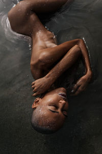 Low section of women swimming in water