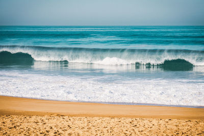 Wave breaking to the beach on the coast in brittany, intentionnal grain