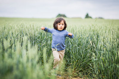 Little eastern handsome baby boy running in the field