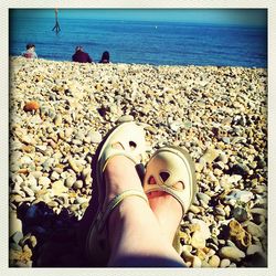 Low section of woman relaxing on beach